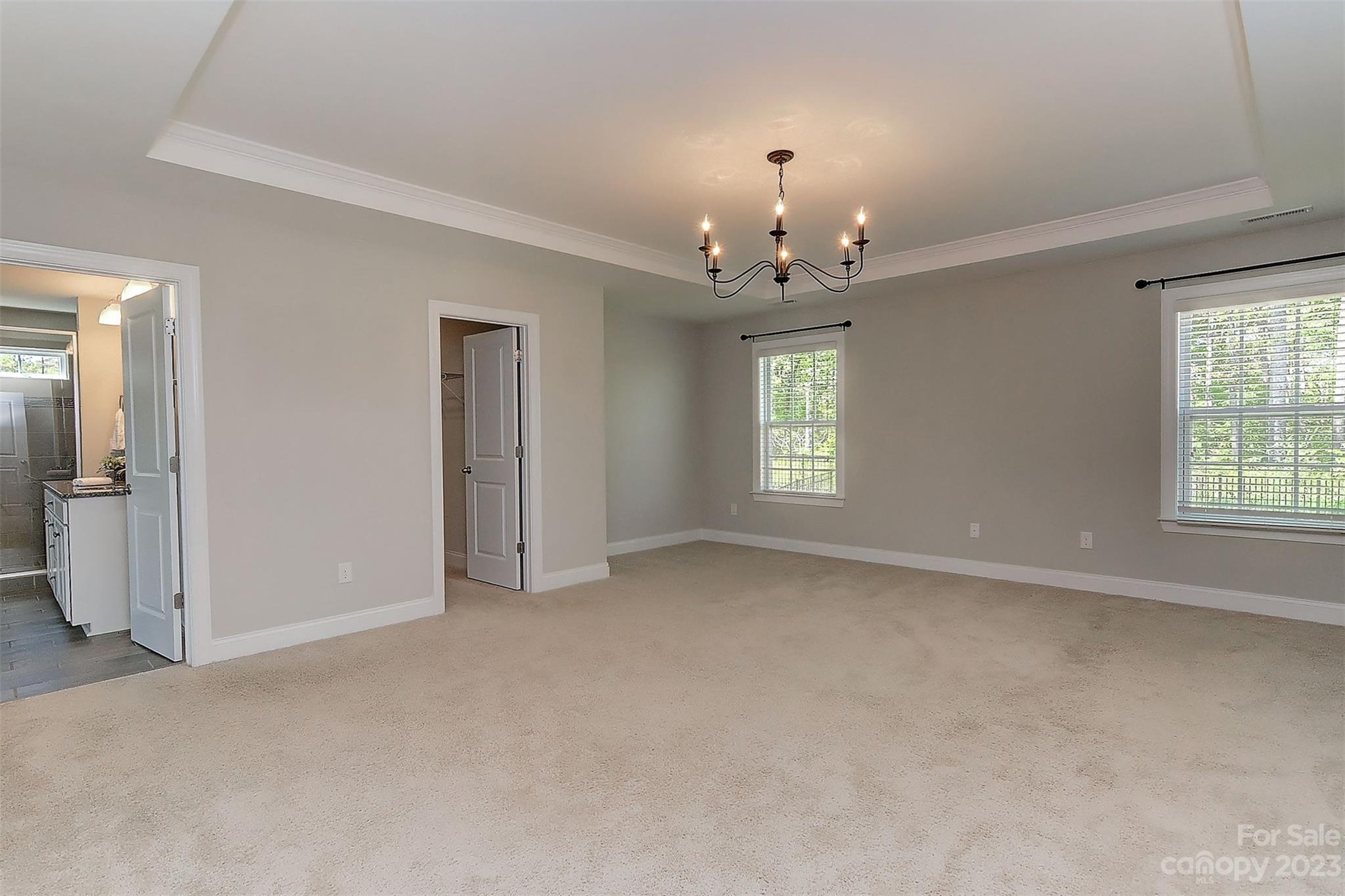 11266 Trailside Road Concord, NC 28027 - Photo 32 of 45 an empty room with chandelier fan and windows