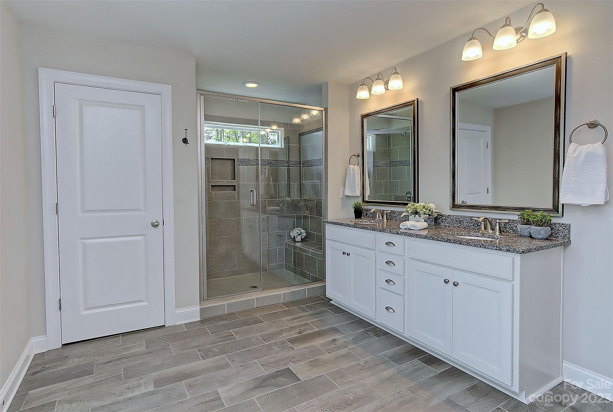 11266 Trailside Road Concord, NC 28027 - Photo 33 of 45 a bathroom with a double vanity sink mirror and shower