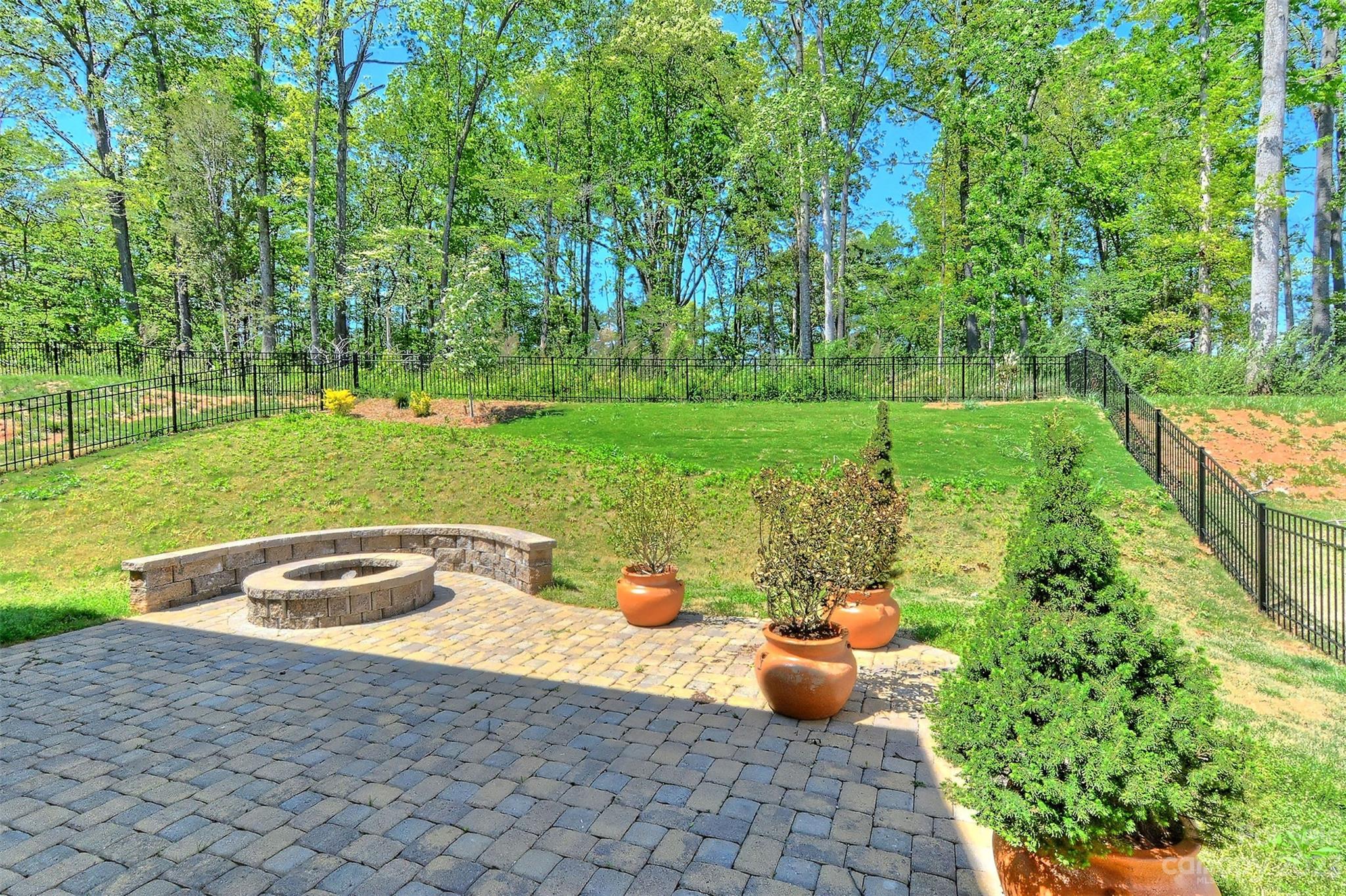 11266 Trailside Road Concord, NC 28027 - Photo 42 of 45 a view of a backyard with table and chairs plants and large trees