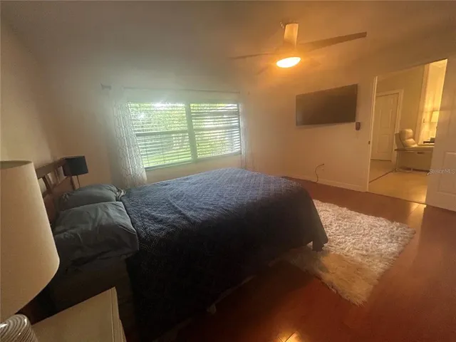 a bedroom with a bed and a flat screen tv
