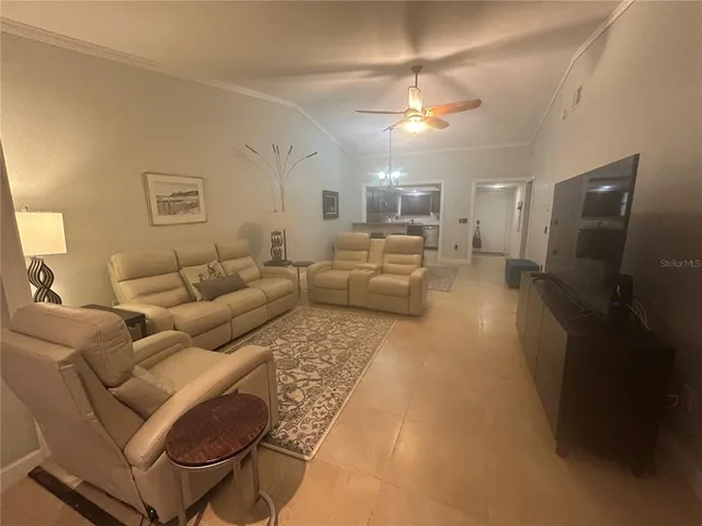 a living room with furniture and a chandelier