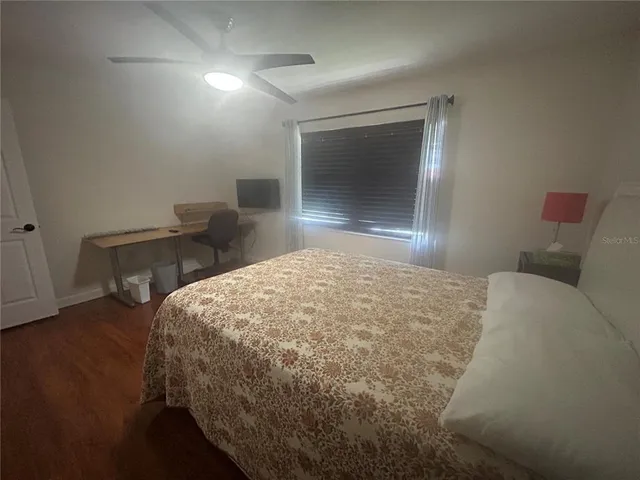 a bedroom with a bed and a potted plant