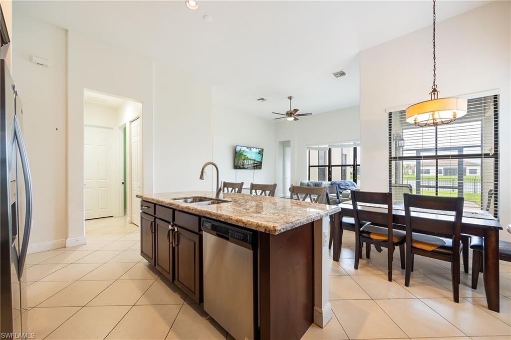 5116 Salerno Street Ave Maria, FL 34142 - Photo 12 of 36 a kitchen with granite countertop a sink and a stove