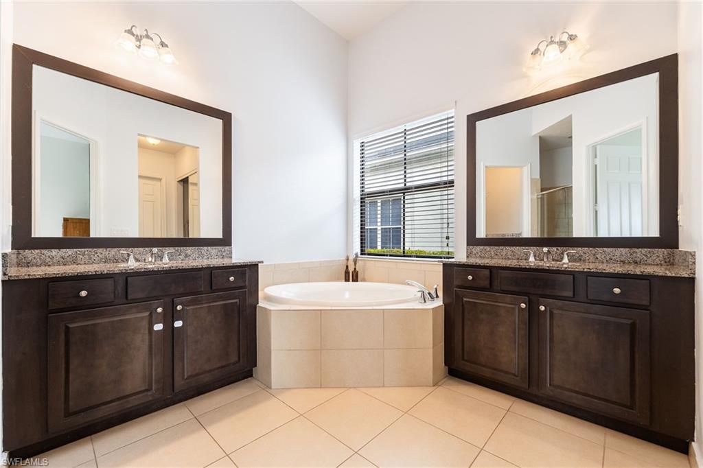 5116 Salerno Street Ave Maria, FL 34142 - Photo 20 of 36 a bathroom with a sink vanity and mirror