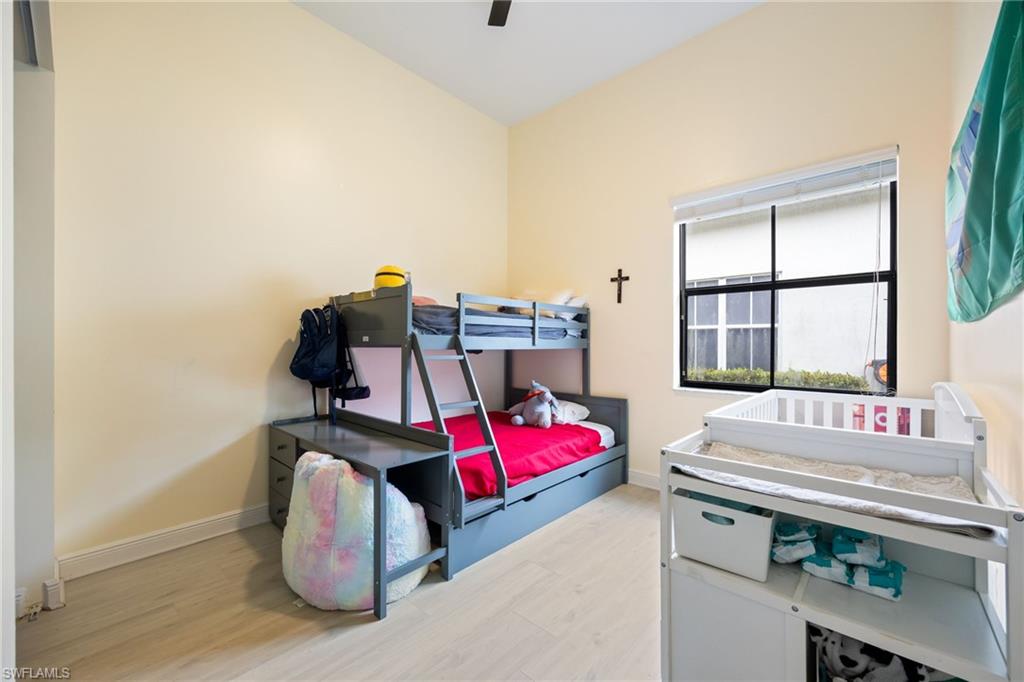 5116 Salerno Street Ave Maria, FL 34142 - Photo 22 of 36 a bedroom with furniture and window