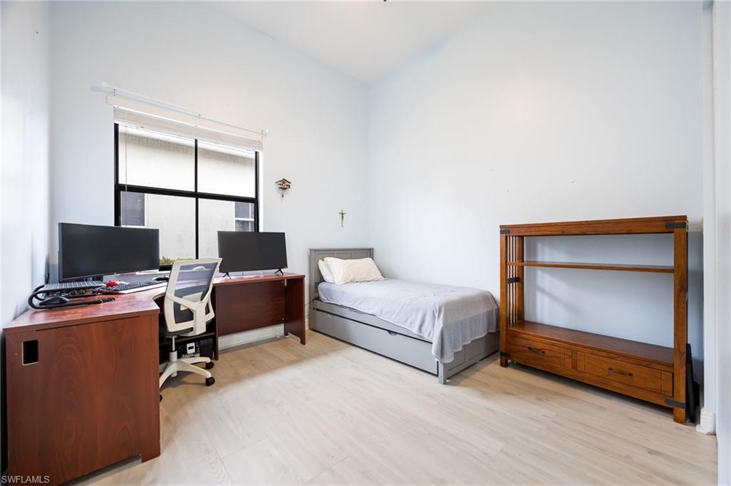 5116 Salerno Street Ave Maria, FL 34142 - Photo 25 of 36 a bedroom with a bed and a desk