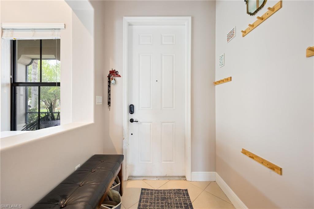5116 Salerno Street Ave Maria, FL 34142 - Photo 3 of 36 a view of a hallway with wooden floor and a bathroom