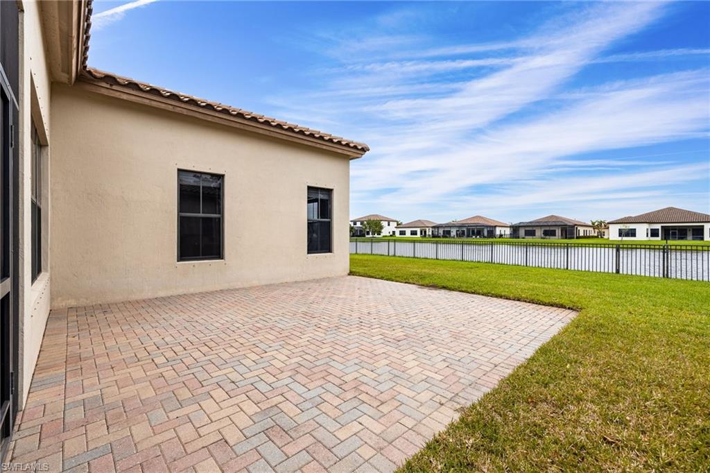 5116 Salerno Street Ave Maria, FL 34142 - Photo 29 of 36 a view of a house with a yard