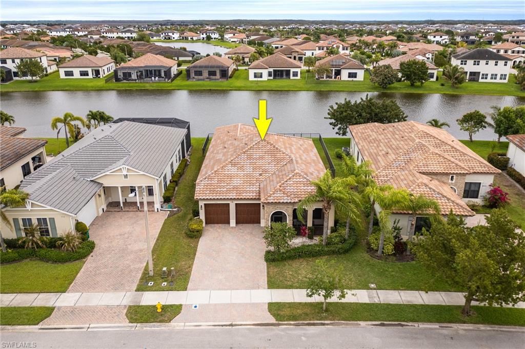 5116 Salerno Street Ave Maria, FL 34142 - Photo 31 of 36 an aerial view of a house with outdoor space and lake view