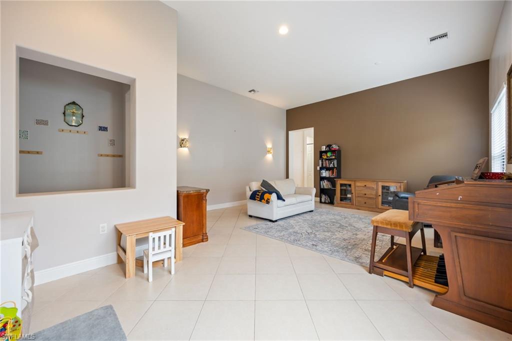 5116 Salerno Street Ave Maria, FL 34142 - Photo 7 of 36 a living room with furniture and a table