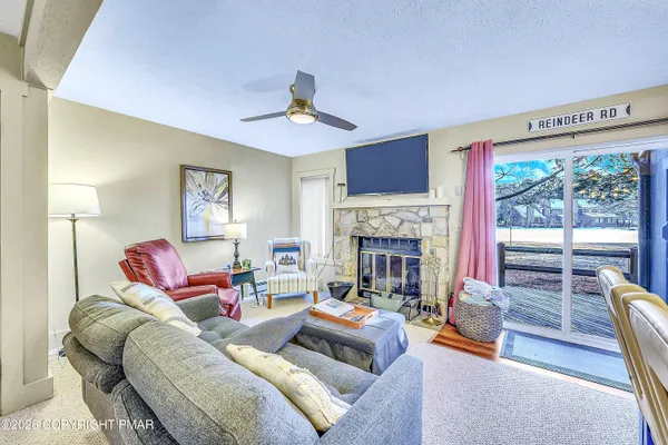 a living room with furniture and a chandelier