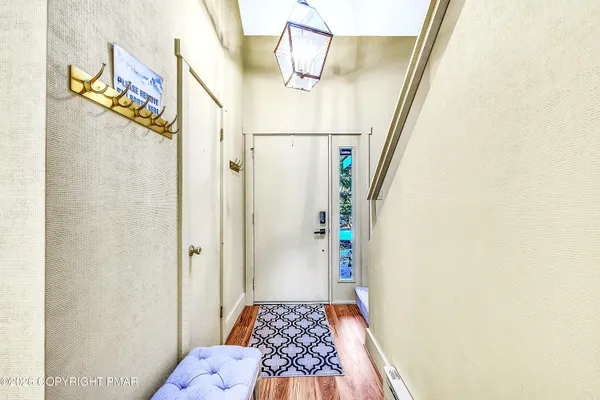 a bathroom with a granite countertop sink a toilet a mirror a bathtub and shower
