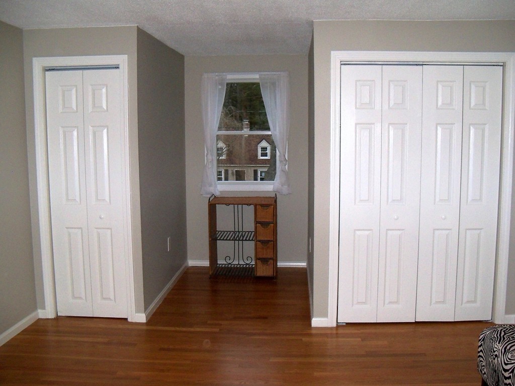 8 Hillcrest Road Canton, MA 02021 - Photo 27 of 29 an empty room with wooden floor closet and windows