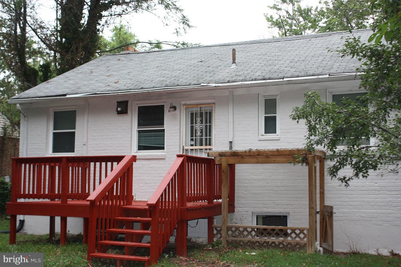 3304 Randolph Road Silver Spring, MD 20902 - Photo 5 of 22 a view of a house with a wooden deck and a yard
