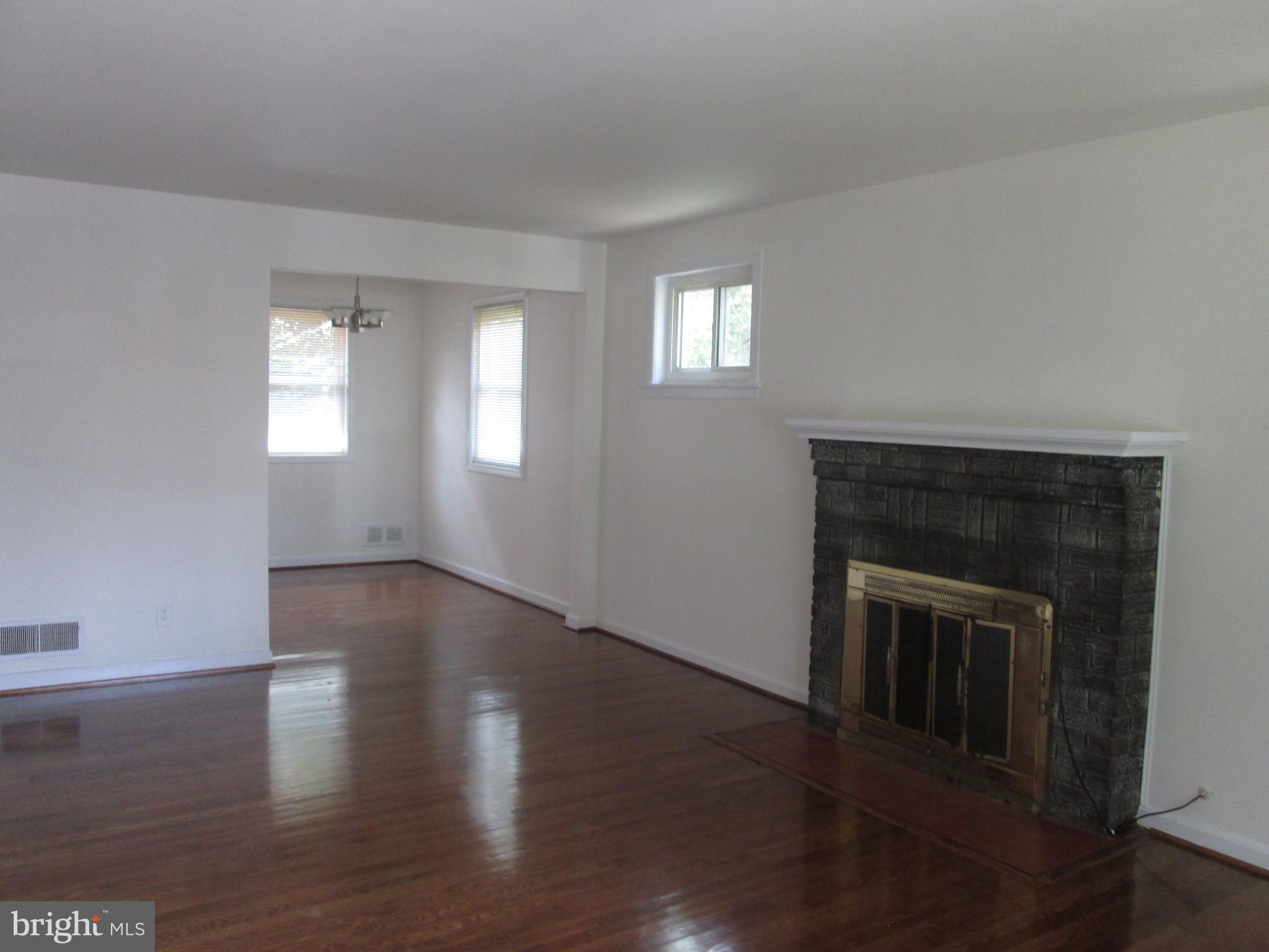 3304 Randolph Road Silver Spring, MD 20902 - Photo 8 of 22 a view of an empty room with wooden floor and a window