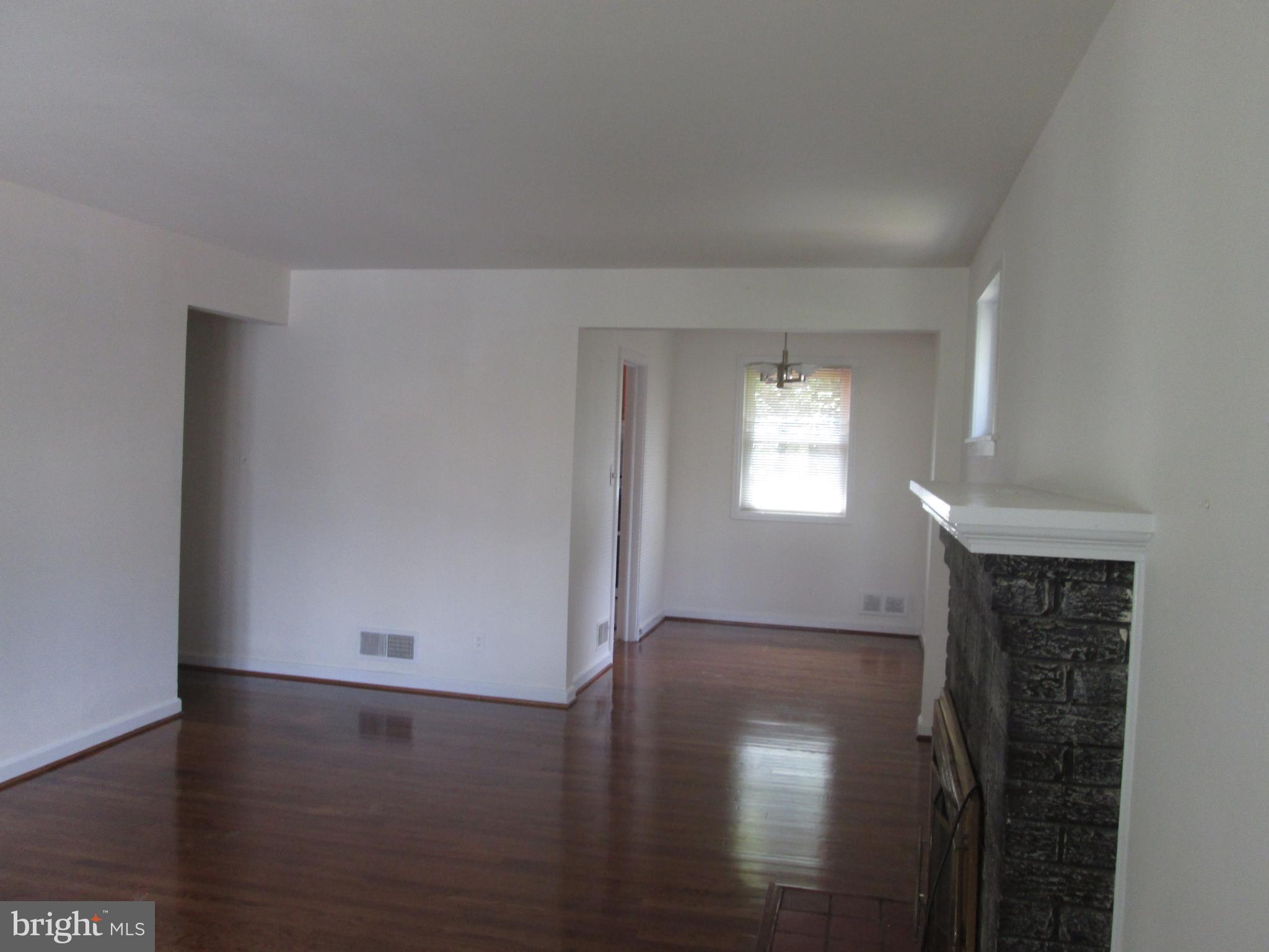 3304 Randolph Road Silver Spring, MD 20902 - Photo 9 of 22 an empty room with wooden floor and windows
