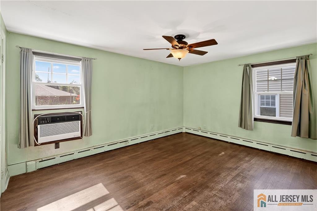 529 4th Street Dunellen, NJ 08812 - Photo 14 of 25 a view of an empty room with a window and wooden floor