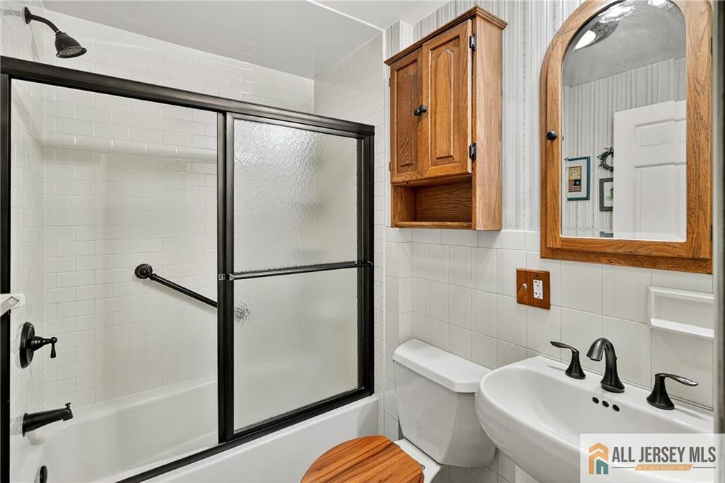 529 4th Street Dunellen, NJ 08812 - Photo 16 of 25 a bathroom with a sink toilet and shower