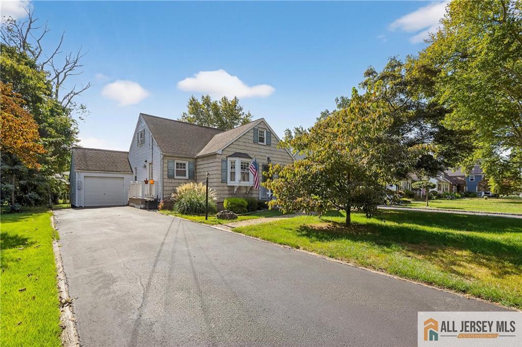 529 4th Street Dunellen, NJ 08812 - Photo 3 of 25 a front view of a house with a yard and garage