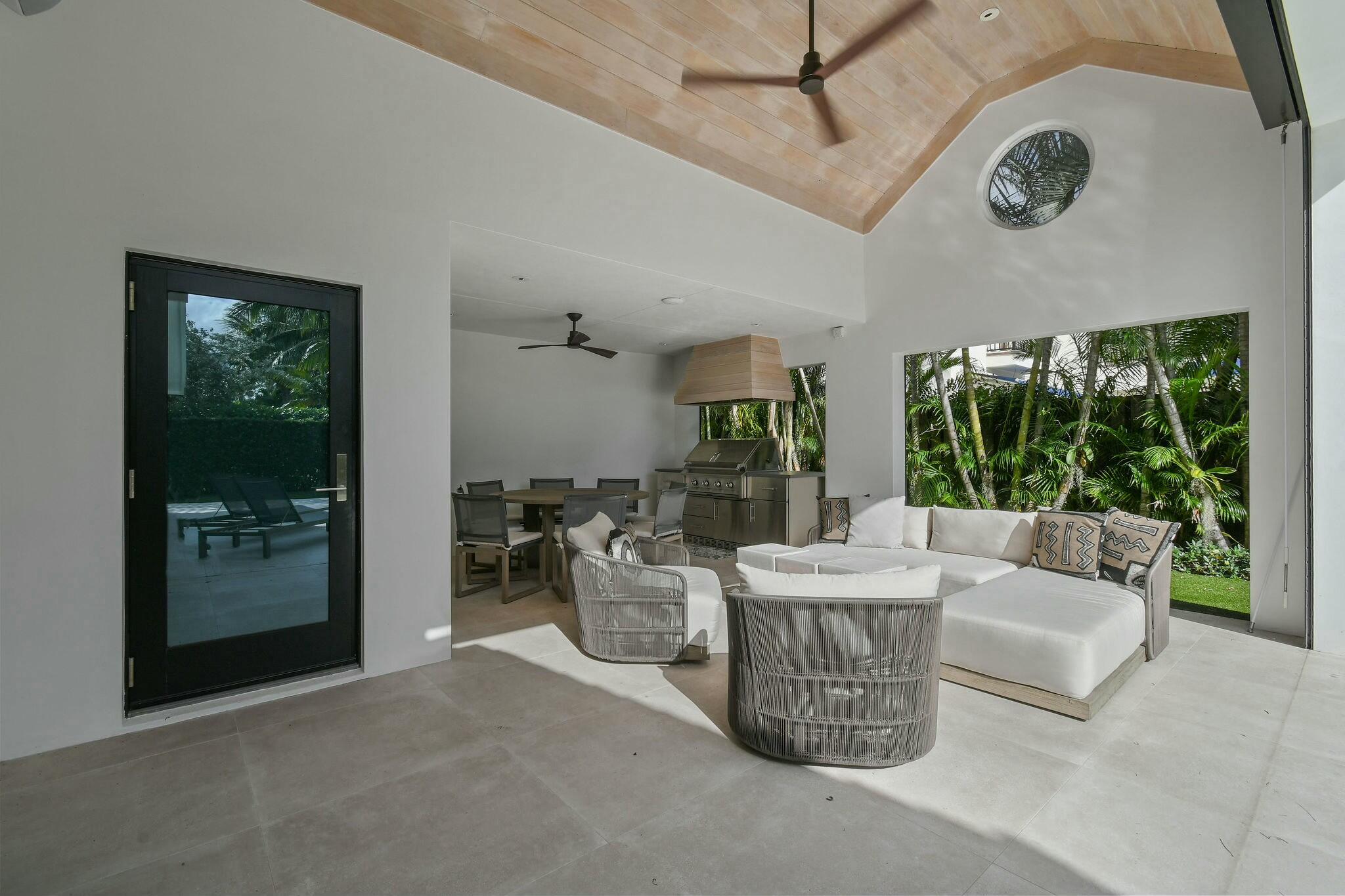 170 Beacon Lane Jupiter Inlet Colony, FL 33469 - Photo 25 of 46 a living room with fireplace furniture and a large window