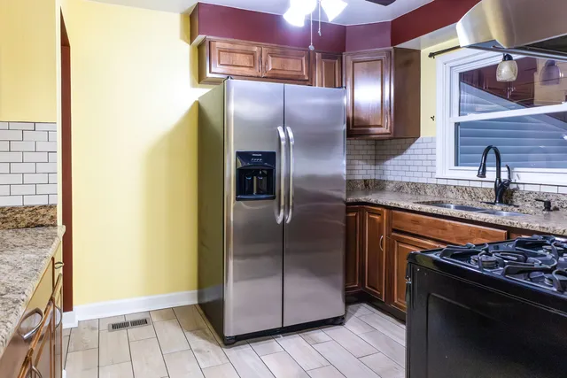 a modern kitchen with granite countertop stainless steel appliances and a counter top space