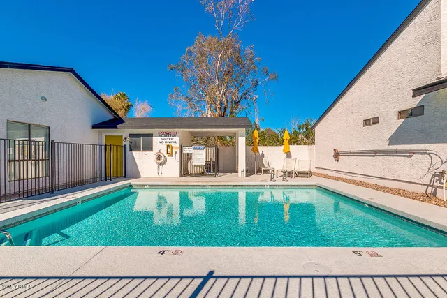 a view of a house with a yard deck and a patio