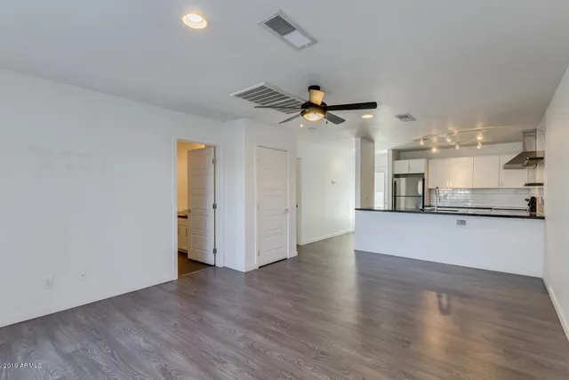 a view of a kitchen with a sink and a ceiling fan