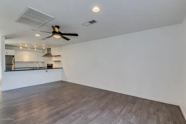 a view of a kitchen with a sink and wooden floor