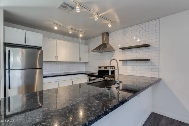 a kitchen with a refrigerator a sink and a stove
