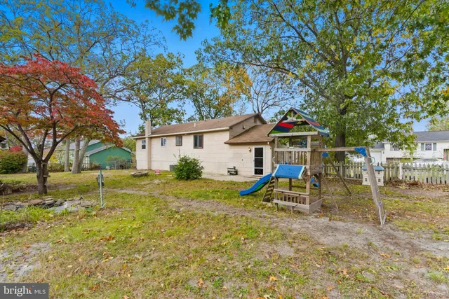 a view of a house with a yard and garage