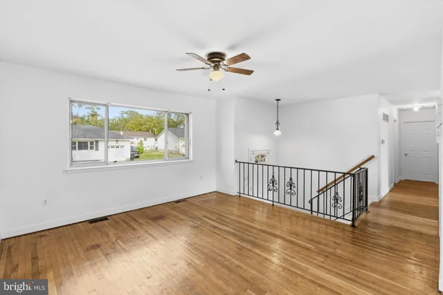 a view of a room with wooden floor and windows
