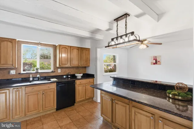 a kitchen with a sink stove and window