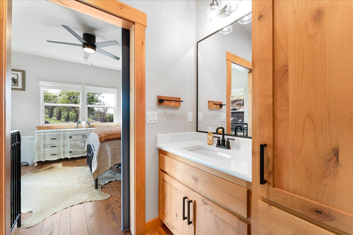 2220 Butte Falls Highway Eagle Point, OR 97524 - Photo 39 of 69 a en suite bathroom with a sink a mirror and next to a window