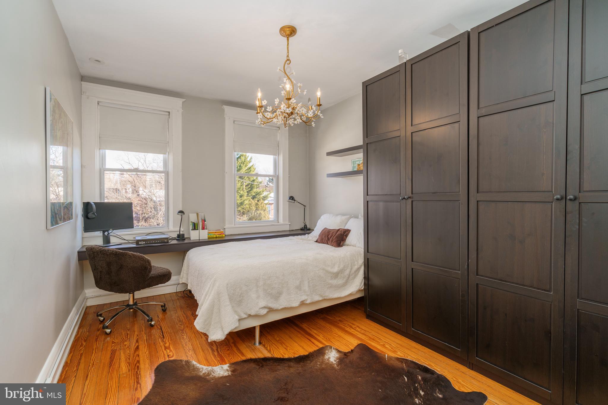 3749 Beech Avenue Baltimore, MD 21211 - Photo 12 of 34 a bedroom with a bed dresser and a window