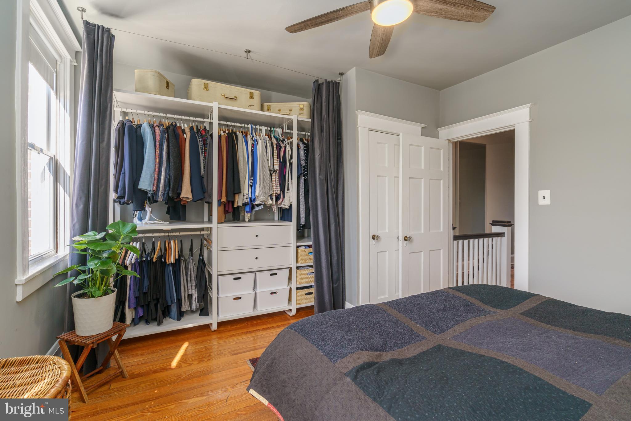 3749 Beech Avenue Baltimore, MD 21211 - Photo 17 of 34 a bedroom with a bed and a chandelier