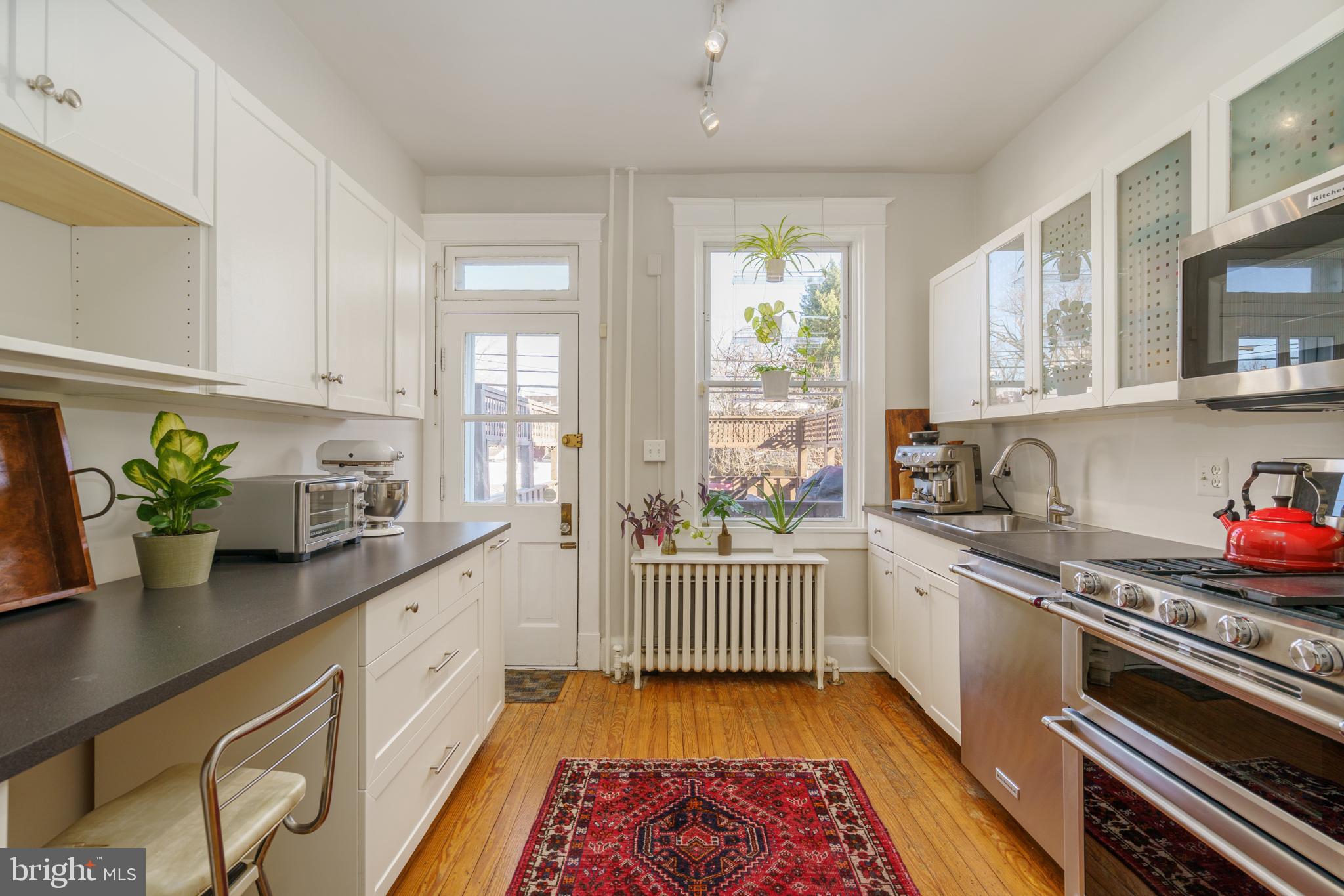 3749 Beech Avenue Baltimore, MD 21211 - Photo 9 of 34 a kitchen with stainless steel appliances sink stove and window