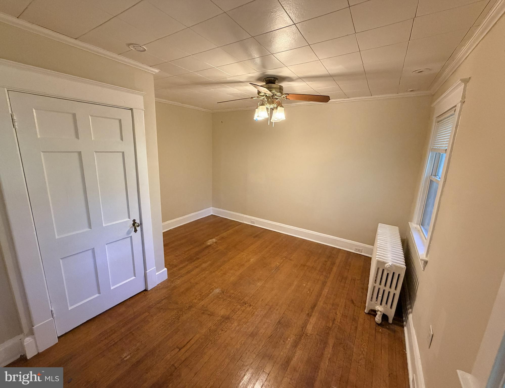 506 Cedarcroft Road Baltimore, MD 21212 - Photo 9 of 16 wooden floor in an empty room with a window