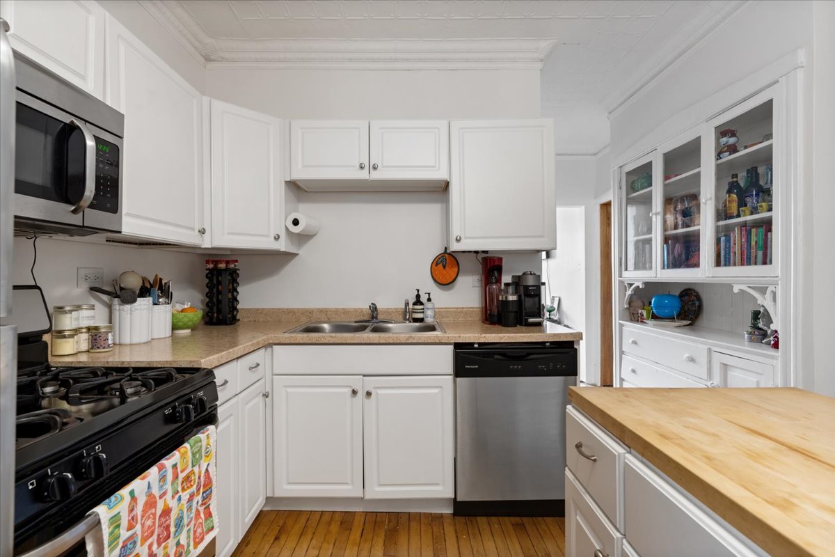 2735 North Ridgeway Avenue Chicago, IL 60647 - Photo 25 of 40 a kitchen with stainless steel appliances a stove a sink and a microwave