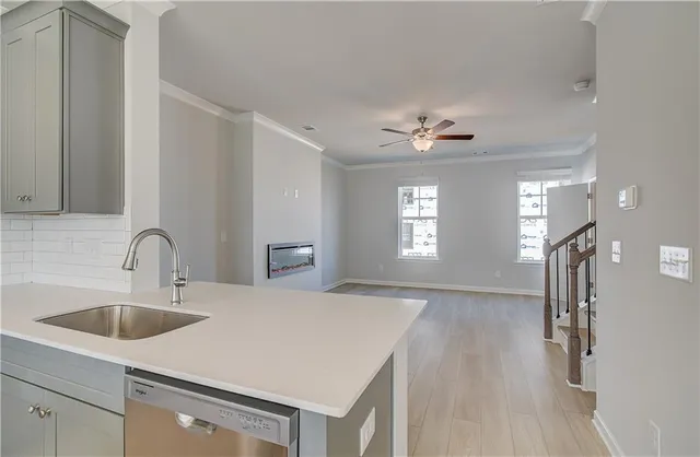 a kitchen with a sink chandelier and refrigerator