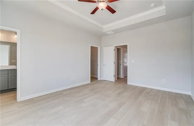 a view of room with hardwood floor and ceiling fan