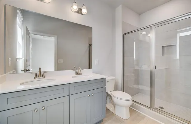 a bathroom with a toilet a sink and a mirror