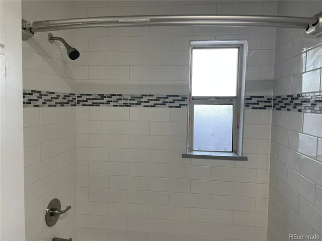 a bathroom with a shower and a sink