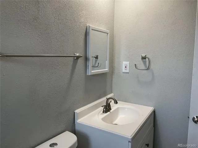 a bathroom with a sink toilet and vanity