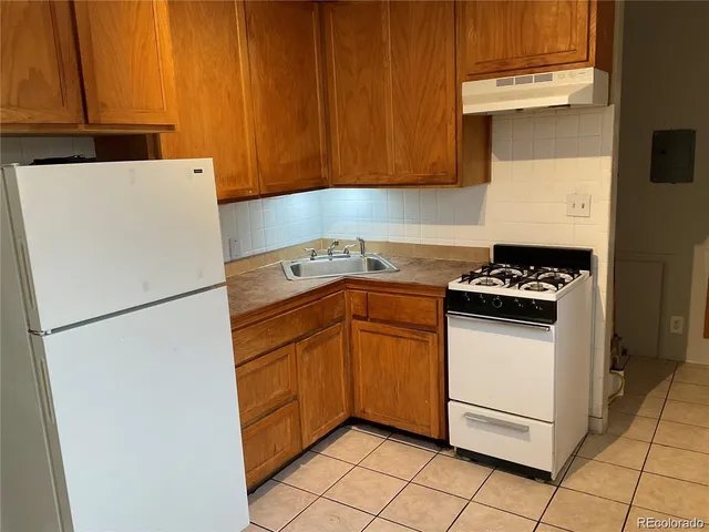 a view of a room with wooden floor and white walls