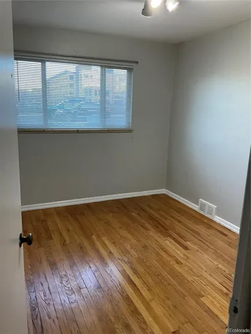 a view of walk in closet with wooden floor