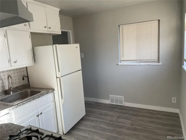 a white refrigerator freezer sitting in a kitchen