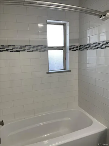 a bathroom with a shower and a bathtub