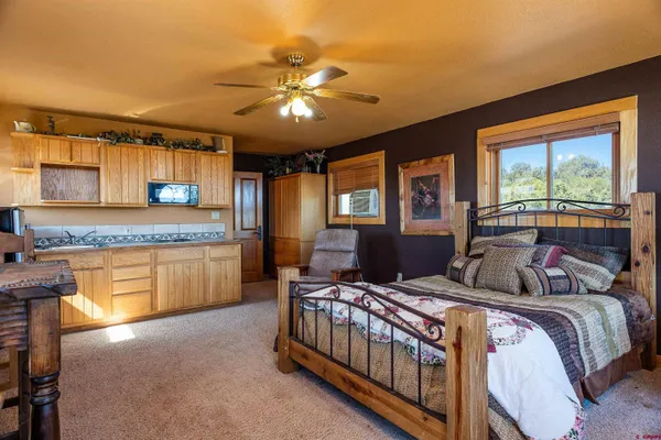 a bedroom with a bed and a chandelier