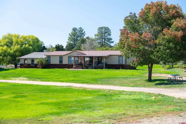 a front view of house with yard and green space
