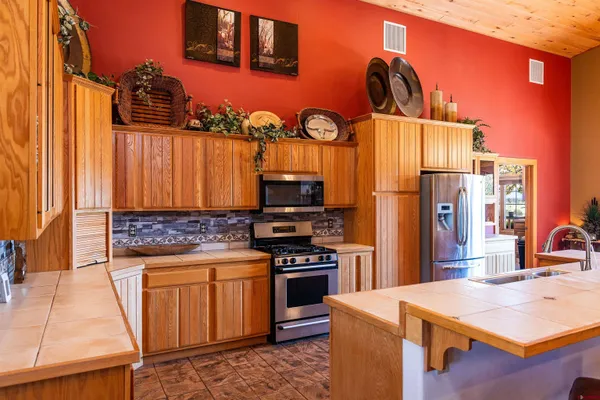 a kitchen view with stainless steel appliances granite countertop a stove and a refrigerator